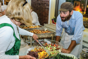 Community-style “Farm Night” dinners are held Wednesday evenings at the Wilburton Inn. Here, Oliver Levis explains the origin of salad ingredients.