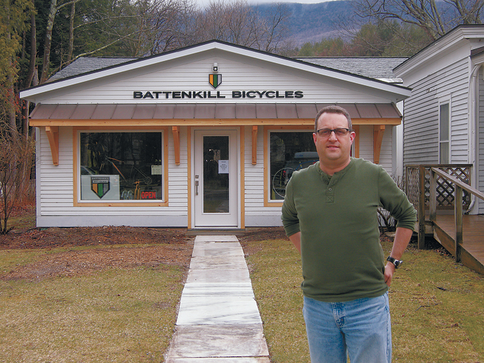 owner of battenkill bicycles outside store