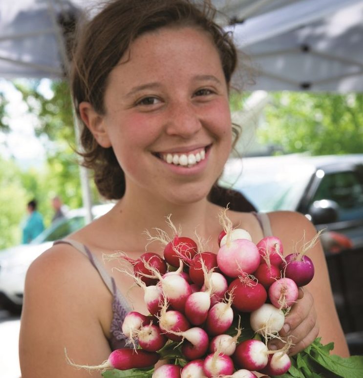 girl holding radishes