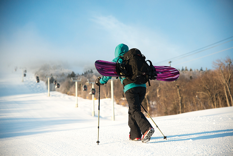 hiking snowboarder