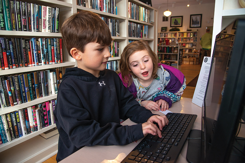 children look at computer at winhall memorial library